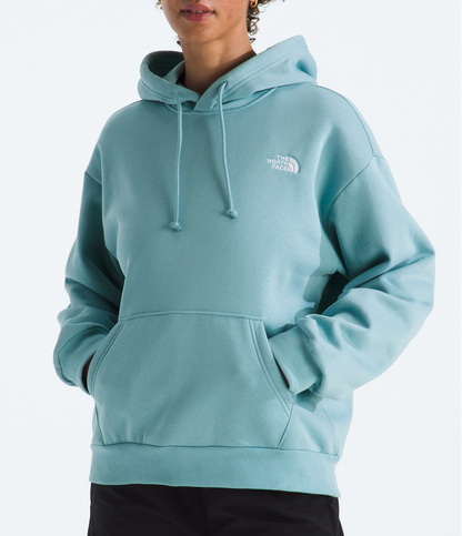 Person wearing a light blue hoodie with a brand logo on a white background
