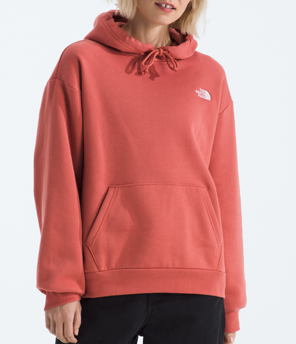 Person wearing a pink hoodie with a logo on a white background