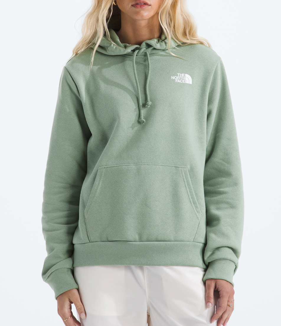 Person wearing a green hoodie with a brand logo on a white background