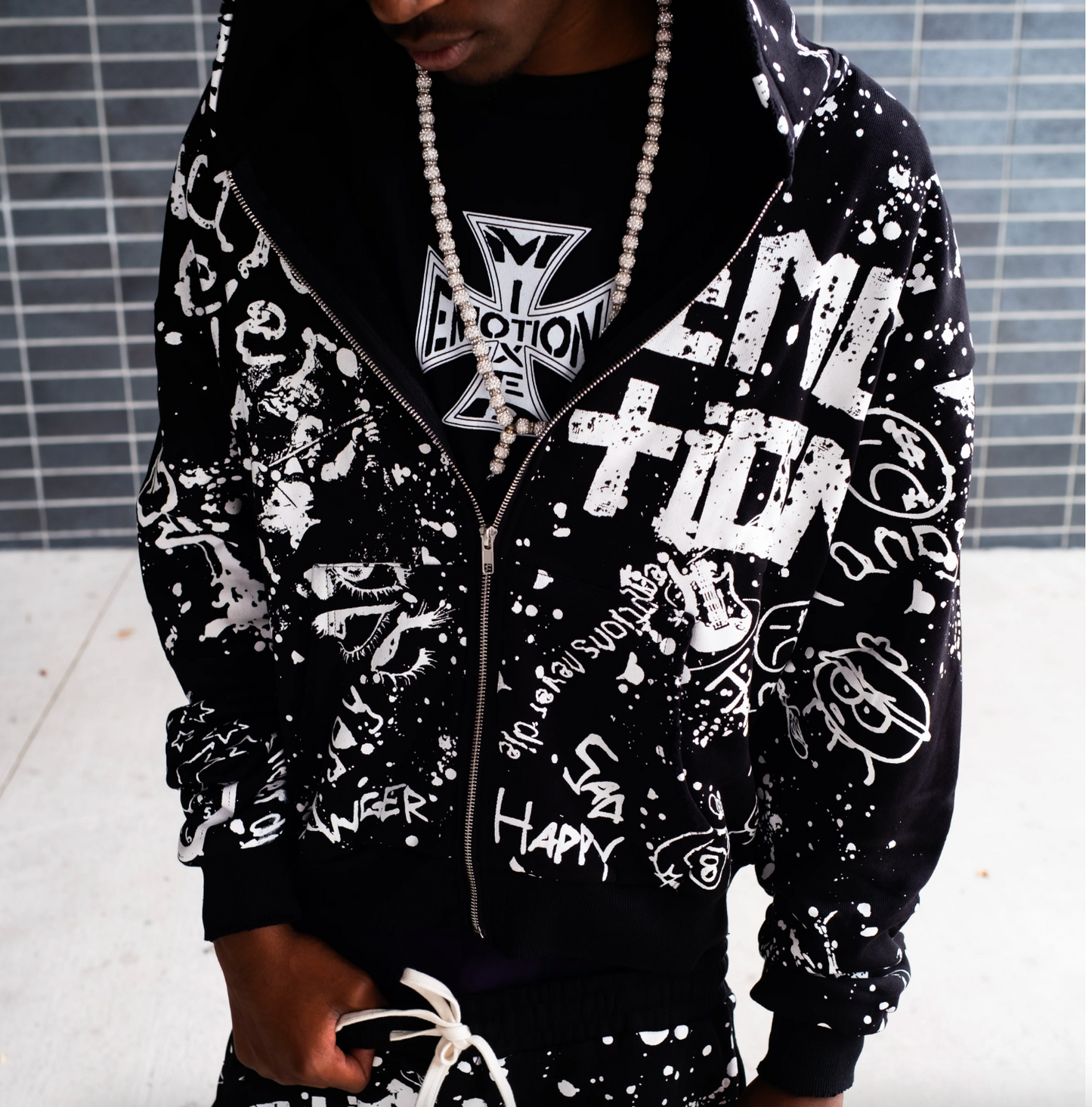Mixed Emotion black graffiti zip hoodie with allover white graphic streetwear artwork and paint splatter design
