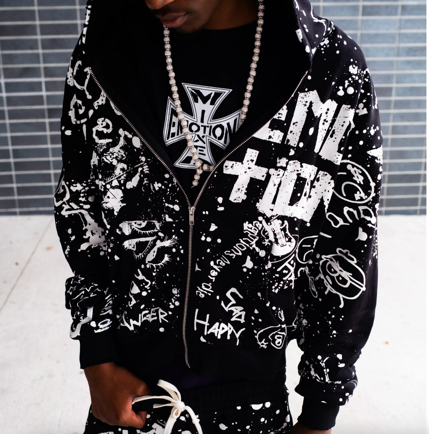 Mixed Emotion black graffiti zip hoodie with allover white graphic streetwear artwork and paint splatter design