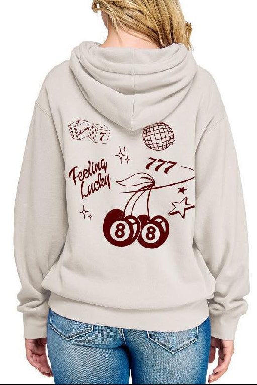 Person wearing a light gray hoodie with lucky design on the back, standing against a white background