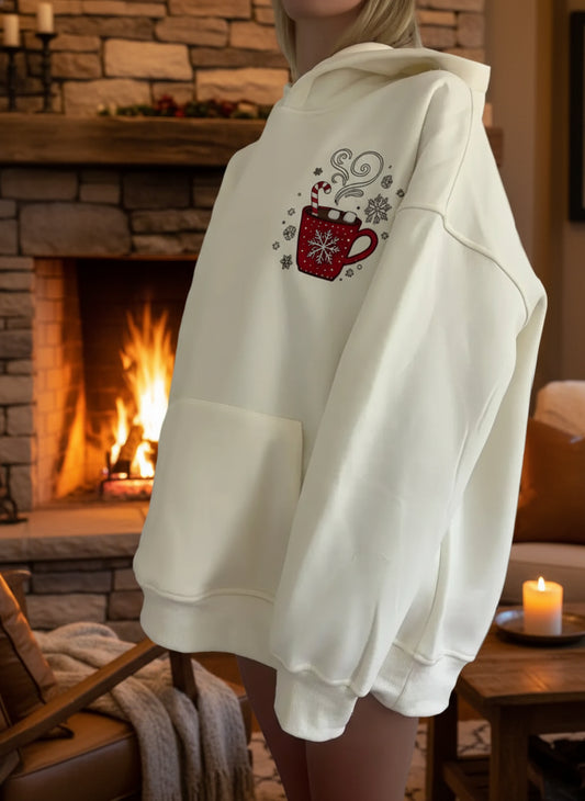 White hoodie with a red mug design on the back against a white door background