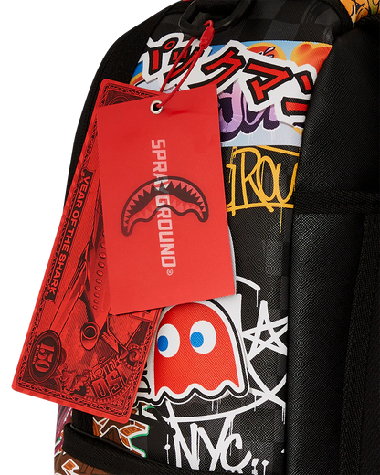 Backpack with colorful graphics and a red 'Sprayground' tag.