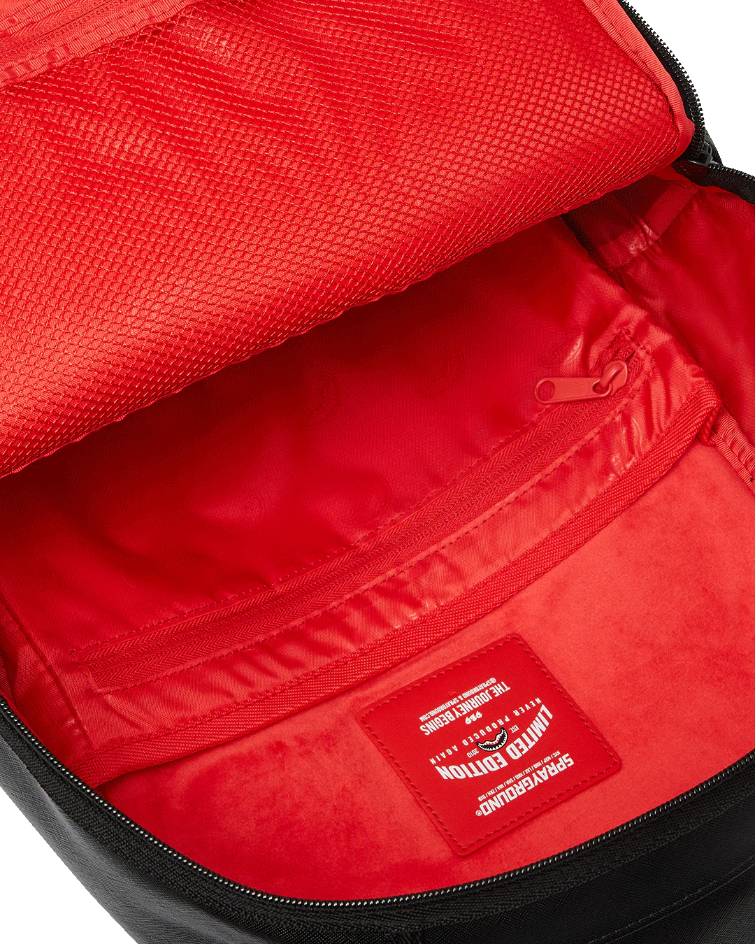 Red interior of a bag with a visible brand label.