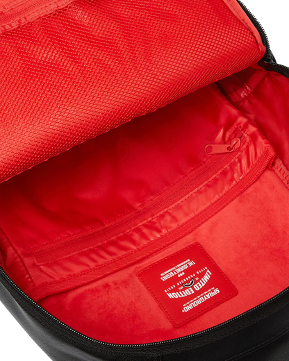 Red interior of a bag with a visible brand label.