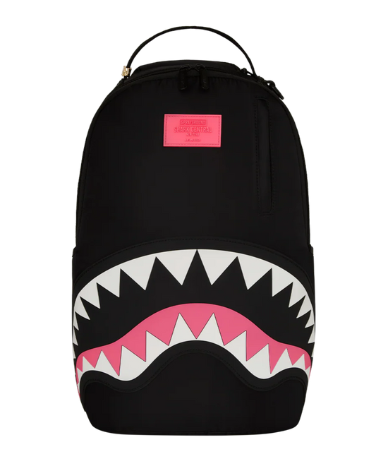 Black backpack with shark mouth design and pink accents on a white background