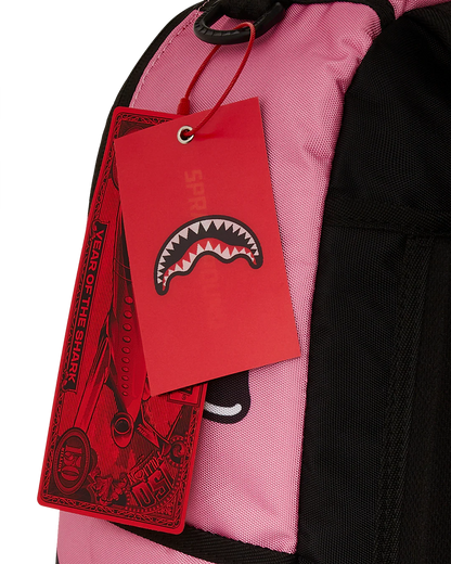 Red tag with a shark design on a pink and black bag