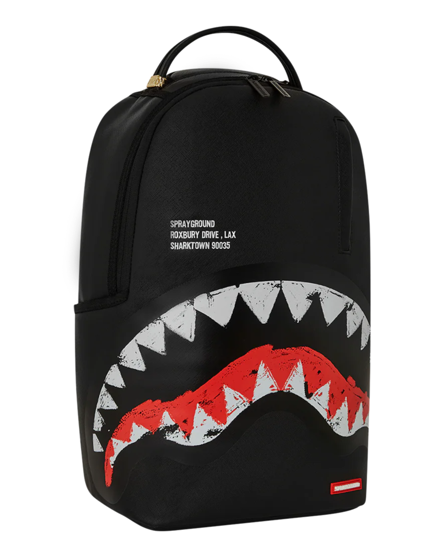 Black backpack with shark mouth design and Sprayground logo on a white background