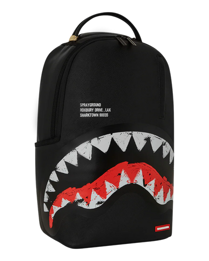 Black backpack with shark mouth design and Sprayground logo on a white background