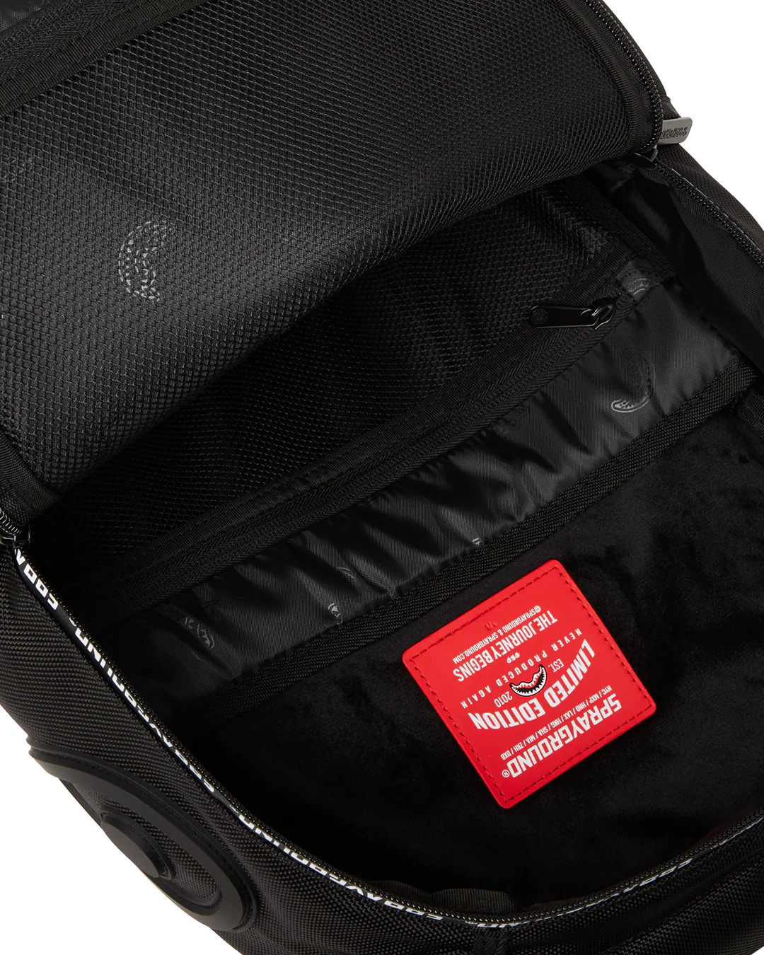 Black backpack interior with a red label on a white background