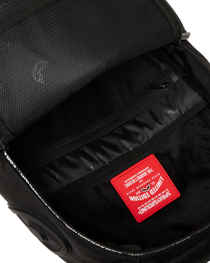 Black backpack interior with a red label on a white background