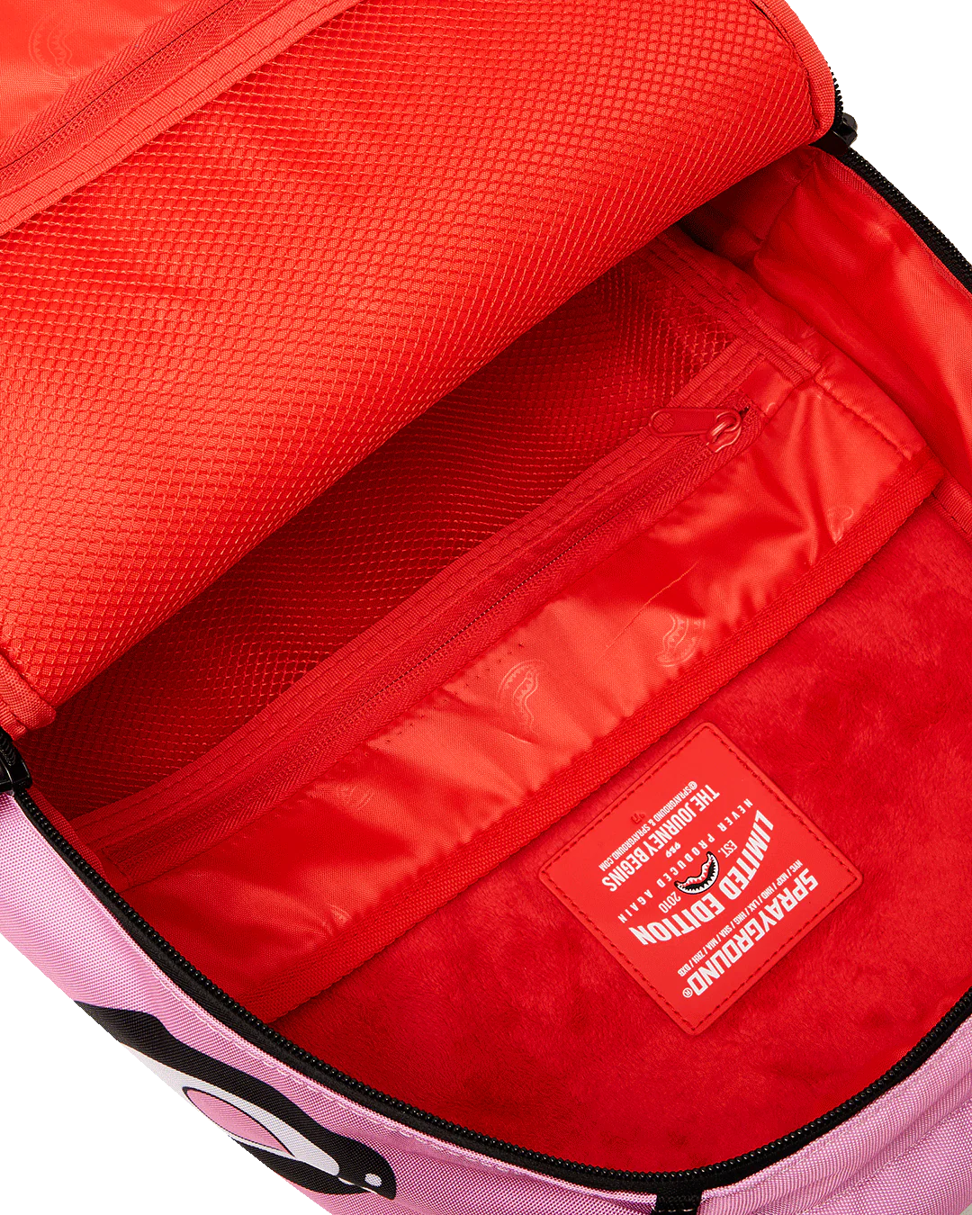 Red backpack interior with a visible brand label on a white background