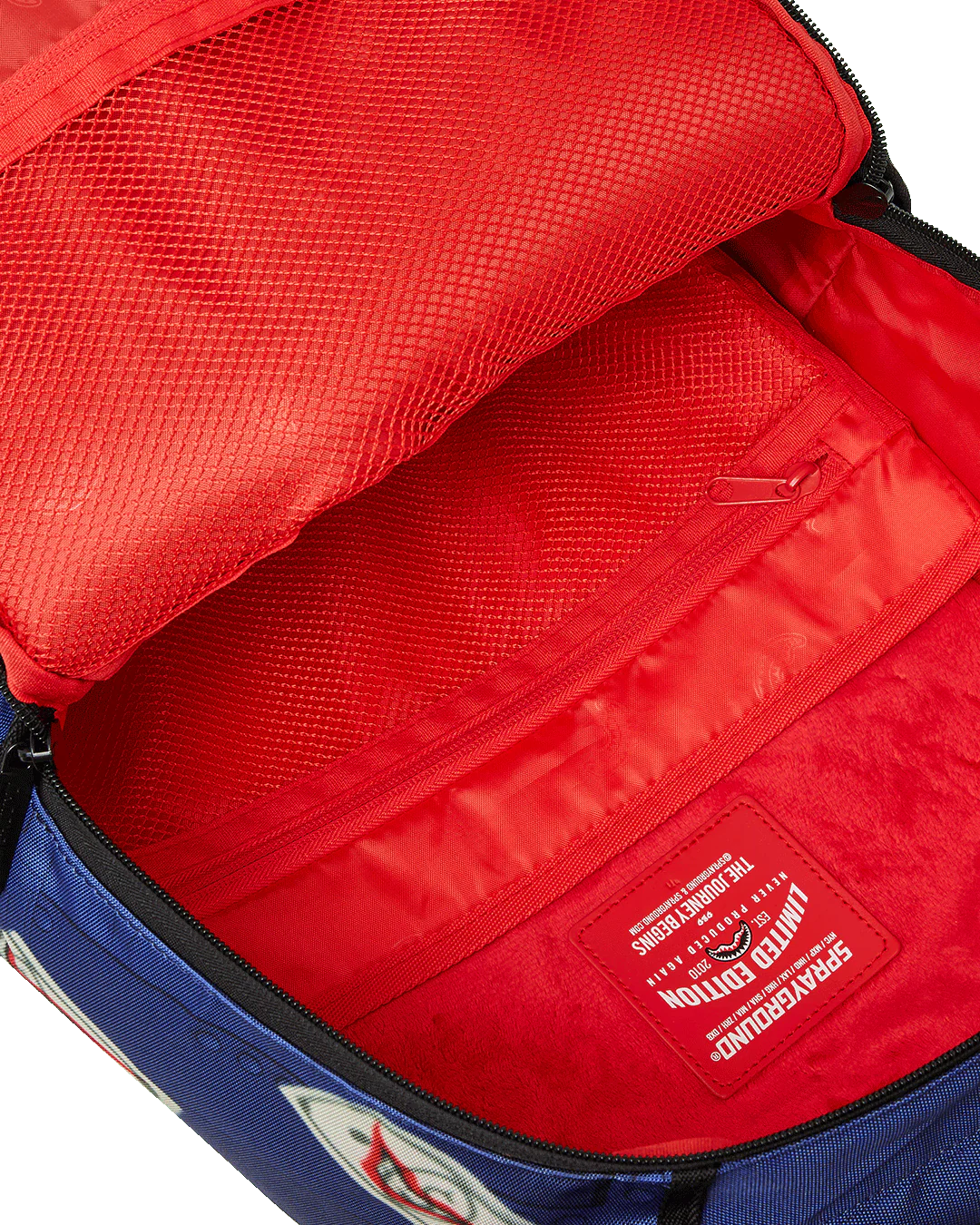Red backpack interior with a visible brand label on a white background