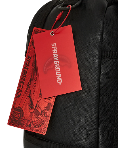 Black backpack with red 'Sprayground' tags attached
