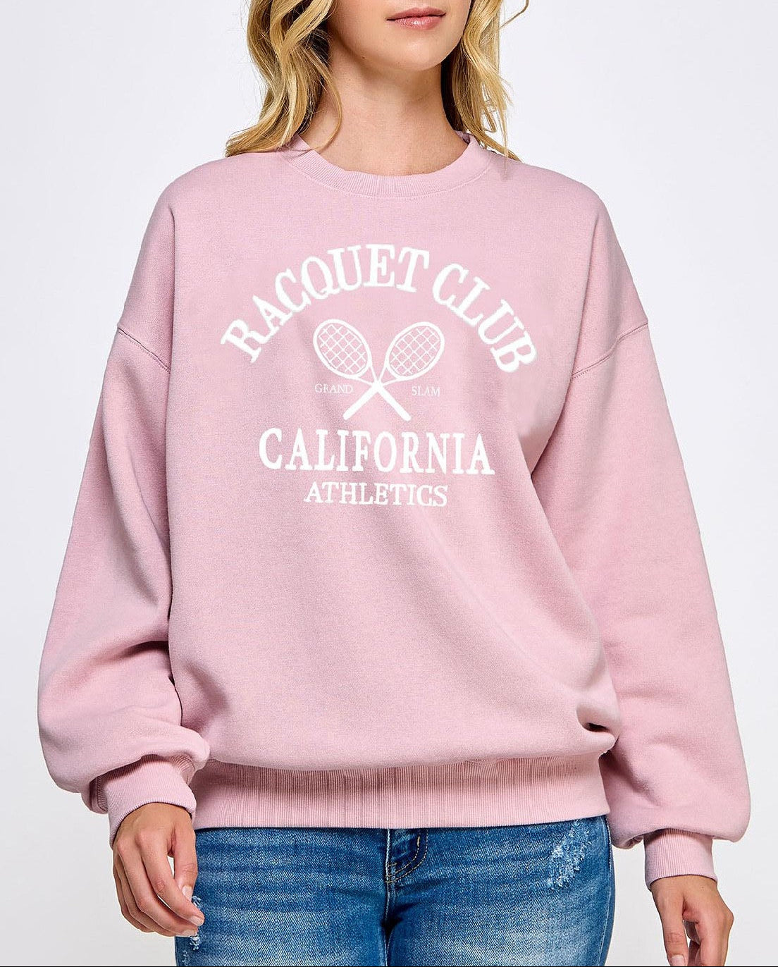 Person wearing a pink sweatshirt with 'Racquet Club California Athletics' text on a white background